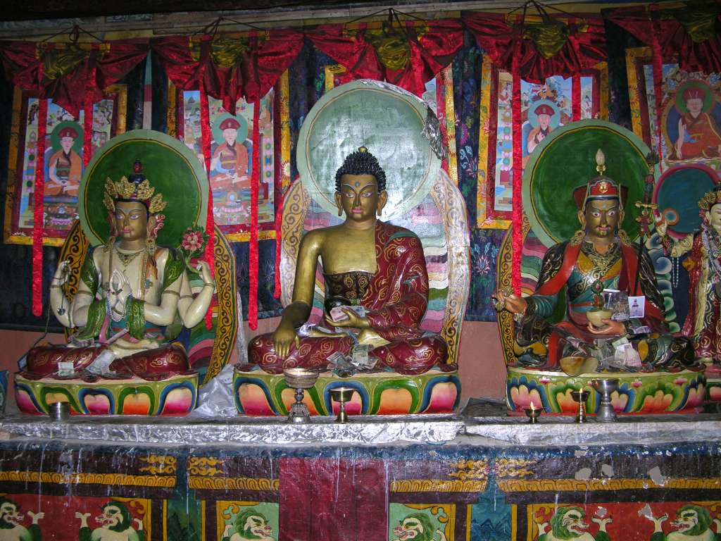 03-3 Avalokiteshvara, Shakyamuni Buddha, and Padmasambhava Here is an altar with three of the most famous Tibetan deities - Avalokiteshvara, Shakyamuni Buddha, and Padmasambhava.